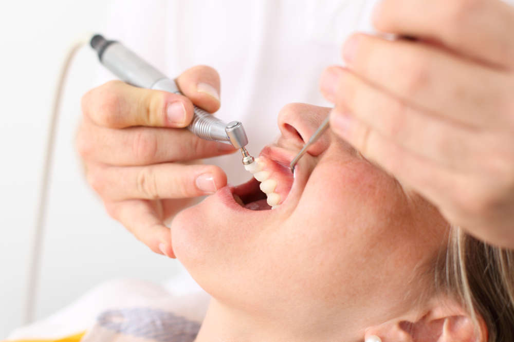 Close-up of a patient receiving a professional teeth cleaning at the dentist
